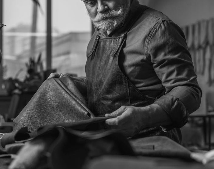 Selective,Focus,Of,Senior,Cobbler,Holding,Pieces,Of,Genuine,Leather